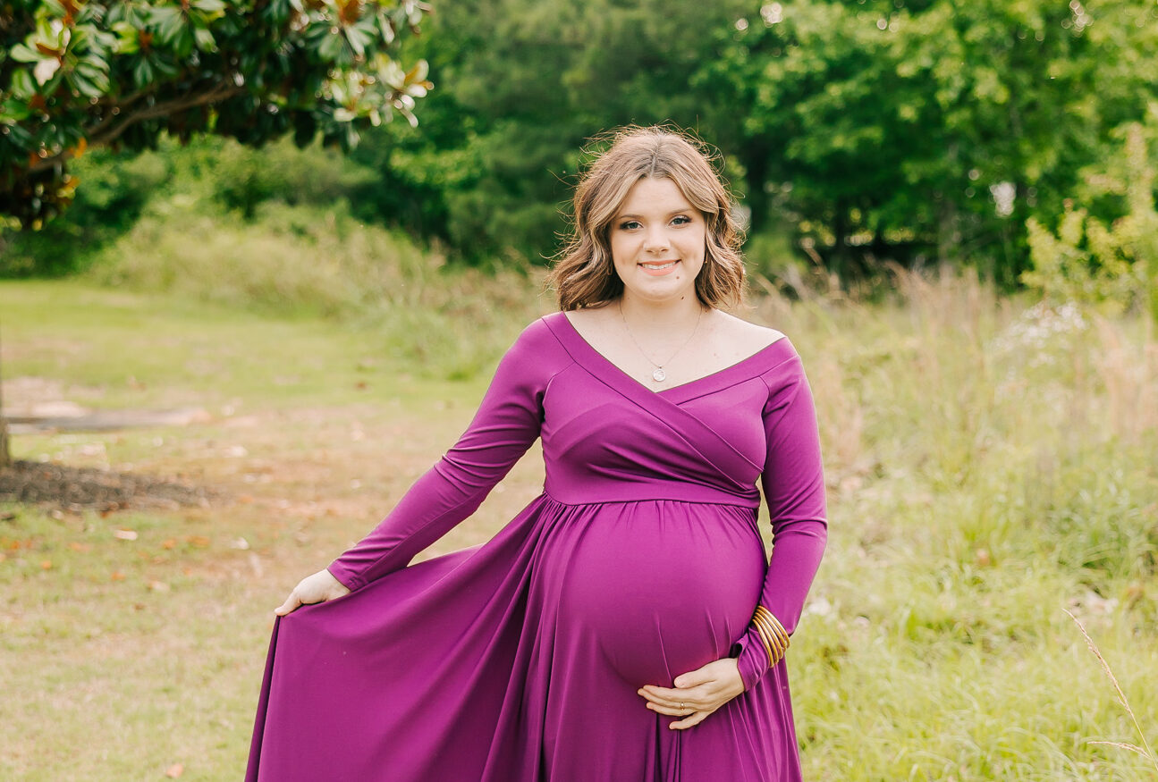 Expecting mom holding her belly during her maternity session with molly berry photography.