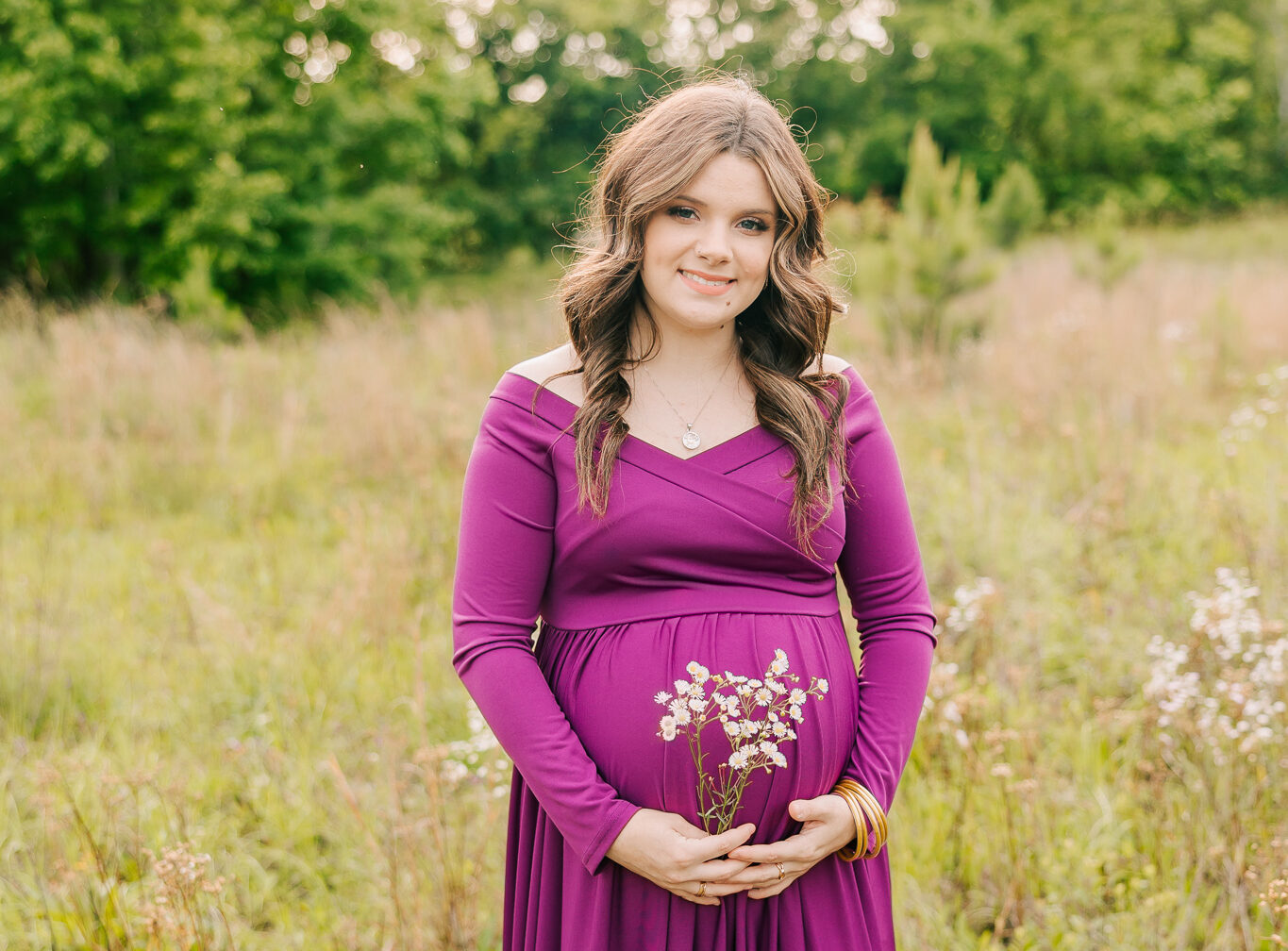 Soon to be mom carrying her sweet baby boy during her maternity portraits with molly berry photography.
