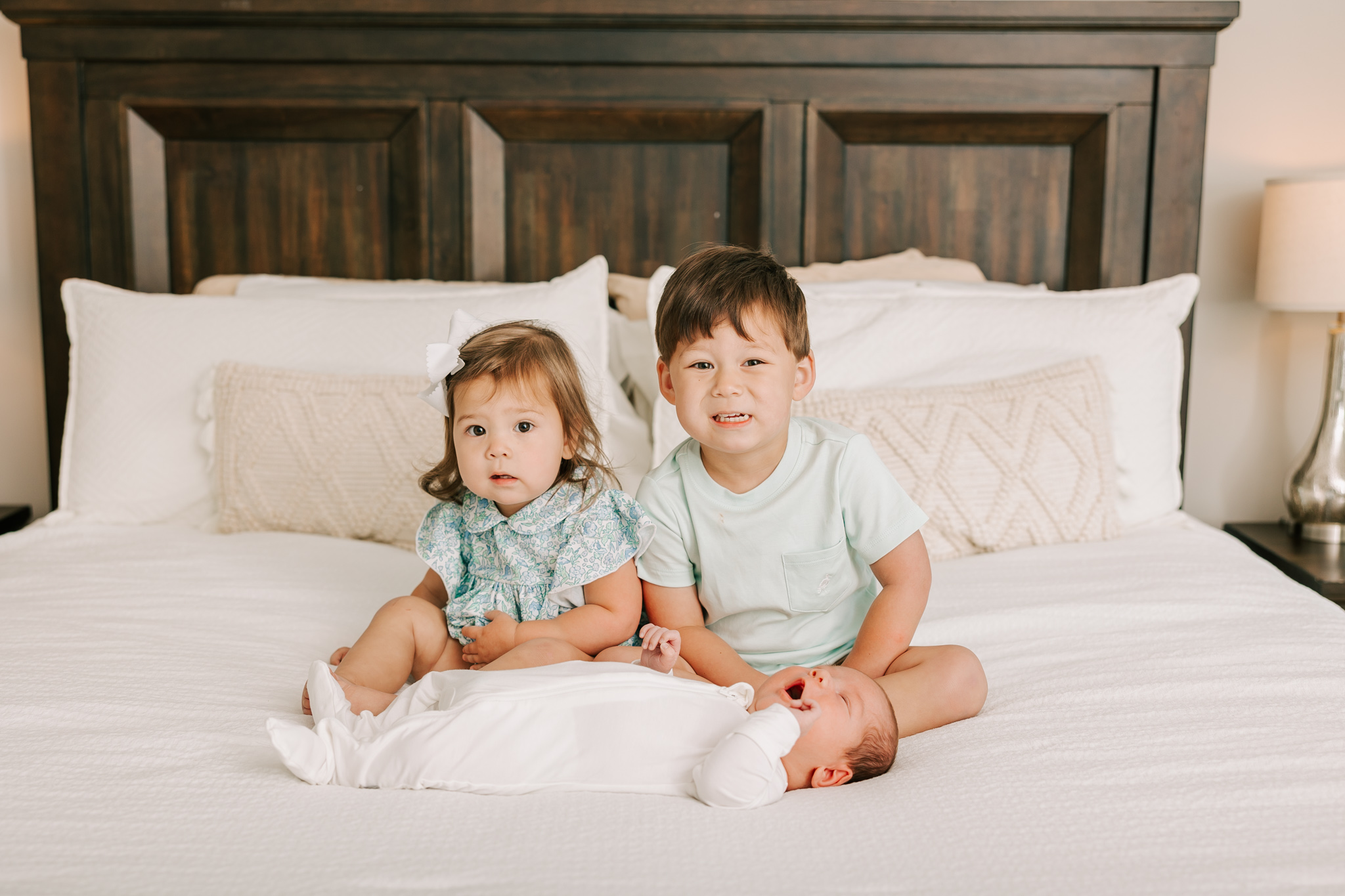 Proud siblings of their baby brother. These three capture a quiet moment during their newborn session.