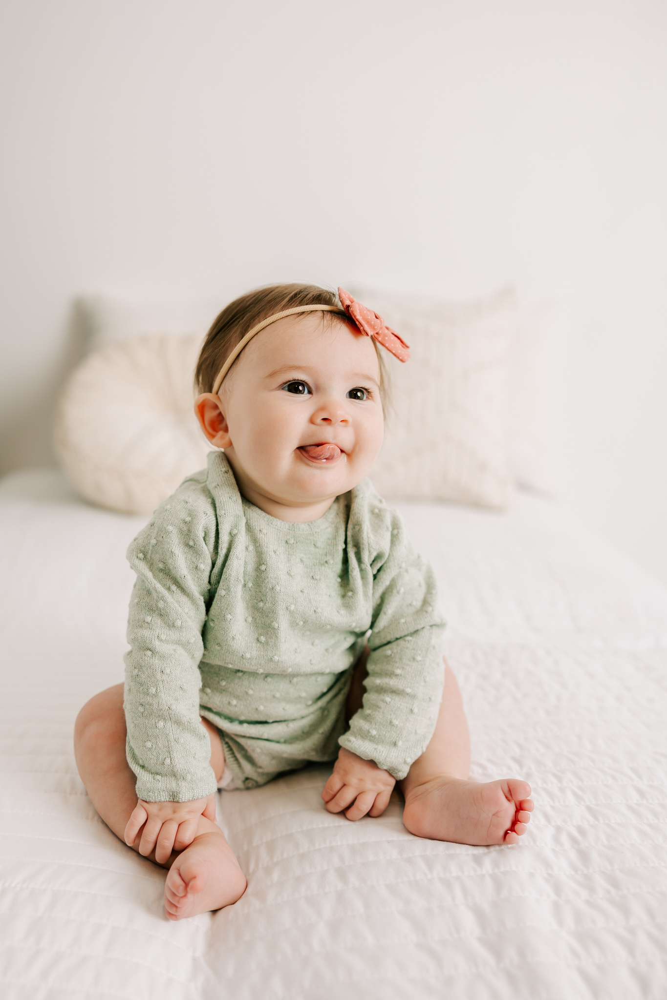 Little six month old girl is showing offer her tongue during her atlanta baby photography session with molly berry photography