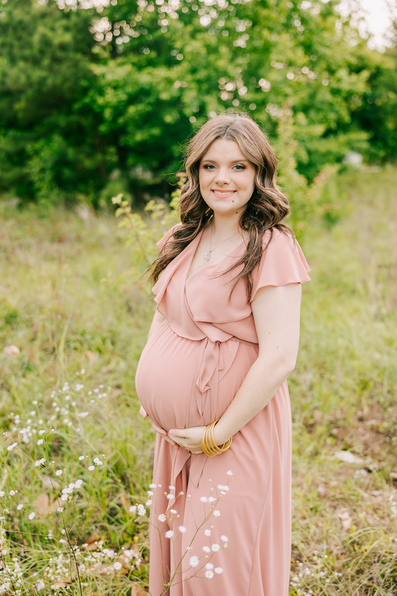 Expecting mom holding her baby belly during her maternity photography session with molly berry.