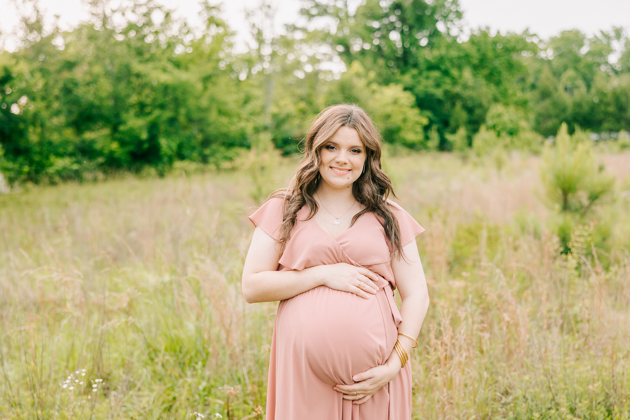 Pregnant mom wearing a pink dress during her Atlanta maternity photoshoot with molly berry.