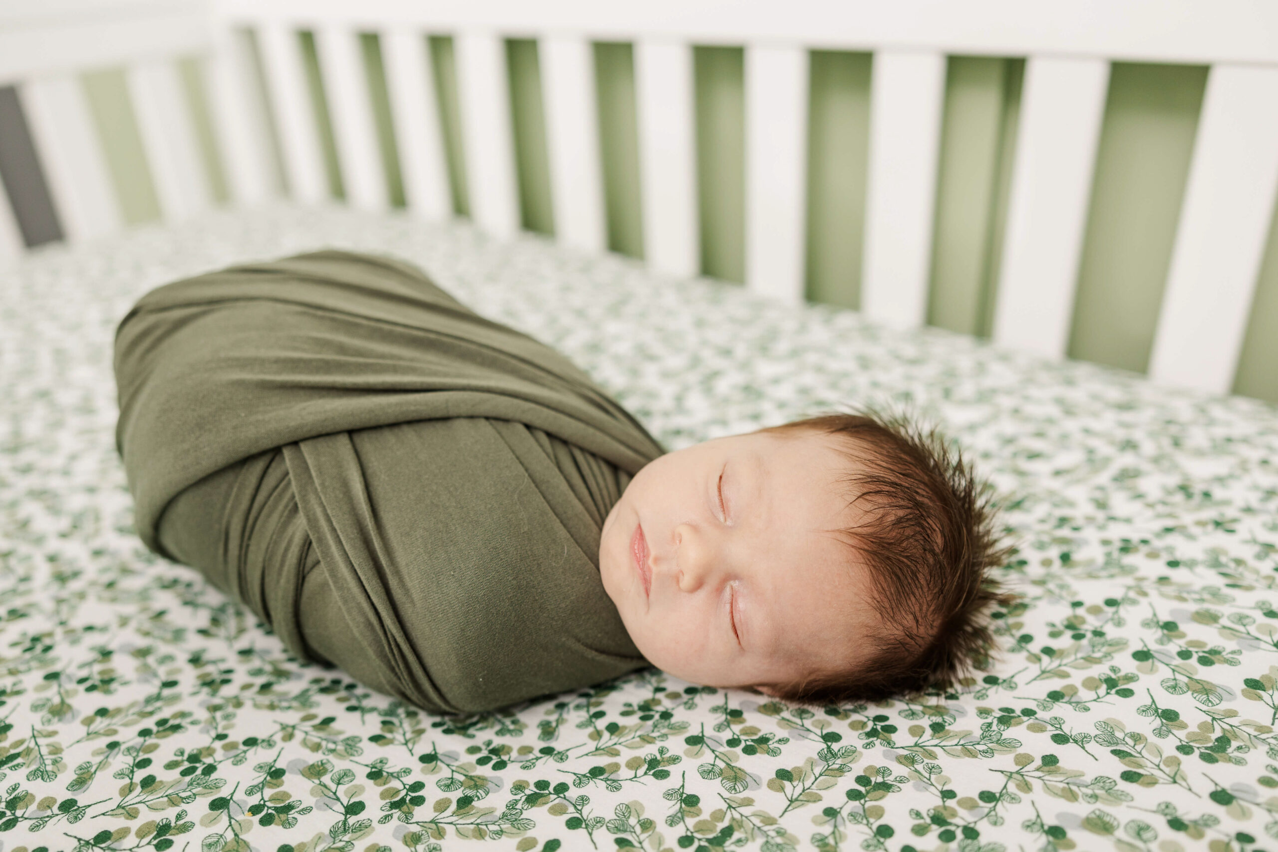 Baby laying in his crib during his newborn session