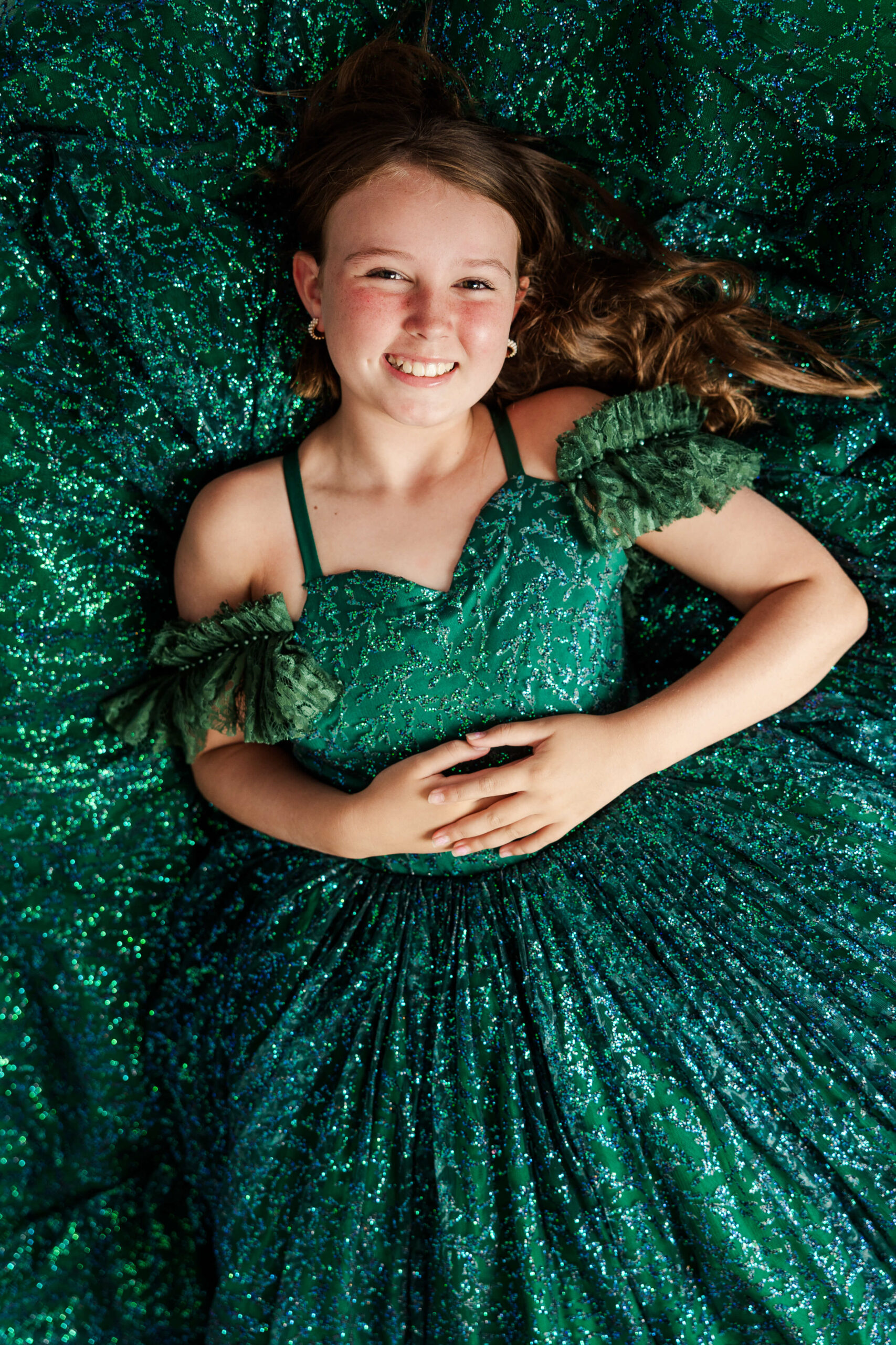 Young girl in green dress during fine art studio session