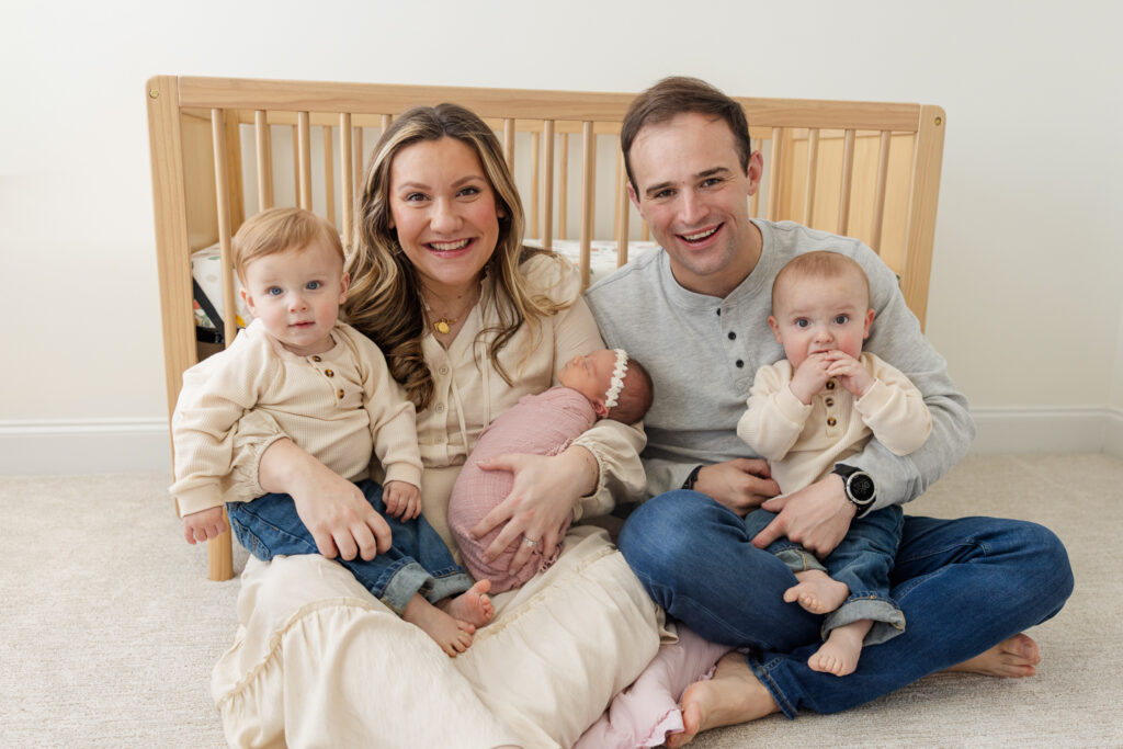 In home newborn session with Molly berry. photo includes mom dad and three children.