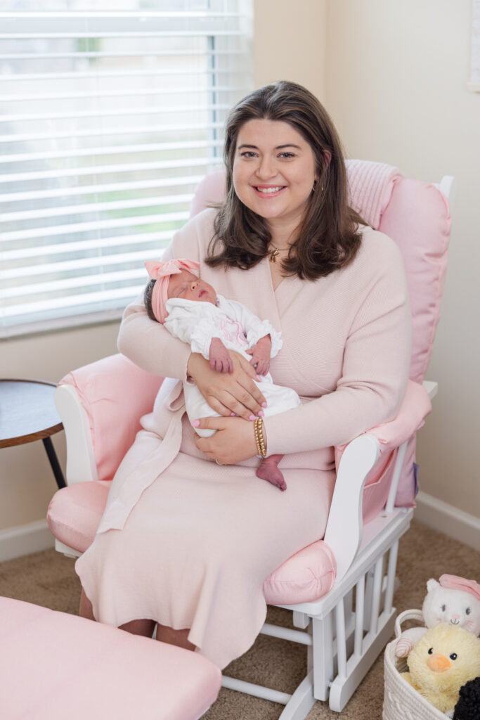 mom holding baby in a rocking chair during newborn session